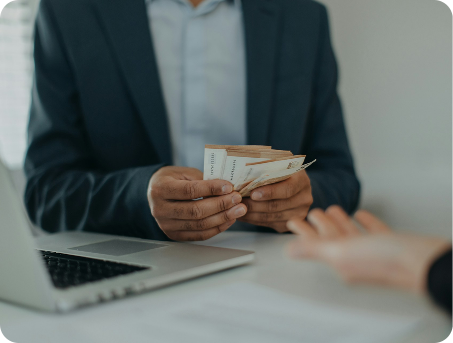 A businessman giving money to another person