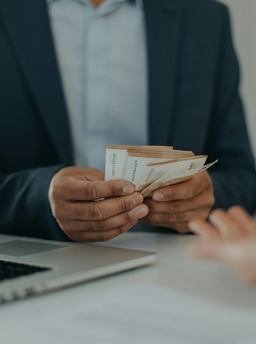 A businessman giving money to another person